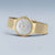Reloj Bering para mujer con correa milanesa dorada, esfera plateada y corona delgada