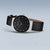Reloj Bering para mujer, esfera negra, correa de cuero negra y bisel decorativo