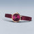 "Reloj de mujer con correa de malla metálica violeta, caja redonda y corona en tono oro rosa."