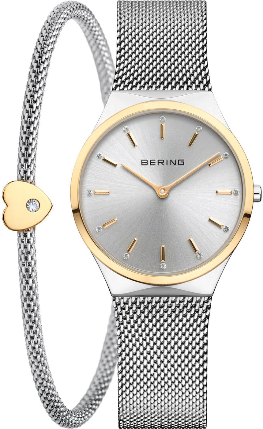 Reloj de mujer: caja redonda dorada, correa milanesa plateada, colgante de corazón