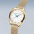 Reloj de mujer con caja dorada y pulsera milanesa de malla fina, vista lateral