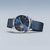 Reloj redondo para hombre con esfera azul, correa milanesa azul y corona lateral