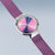 "Reloj de mujer con correa milanesa violeta, caja plateada y esfera multicolor"
