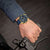 Reloj de hombre con correa azul y bisel dorado, esfera azul con cronógrafo