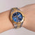 Reloj de mujer: esfera azul, detalles dorados, brazalete de acero inoxidable con subesferas de cronógrafo.