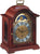 Reloj de mesa de caoba con esfera redonda, marco ornamental dorado y frontal protegido