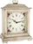 Reloj de mesa de madera con esfera blanca, números romanos, adornos florales y asa de latón