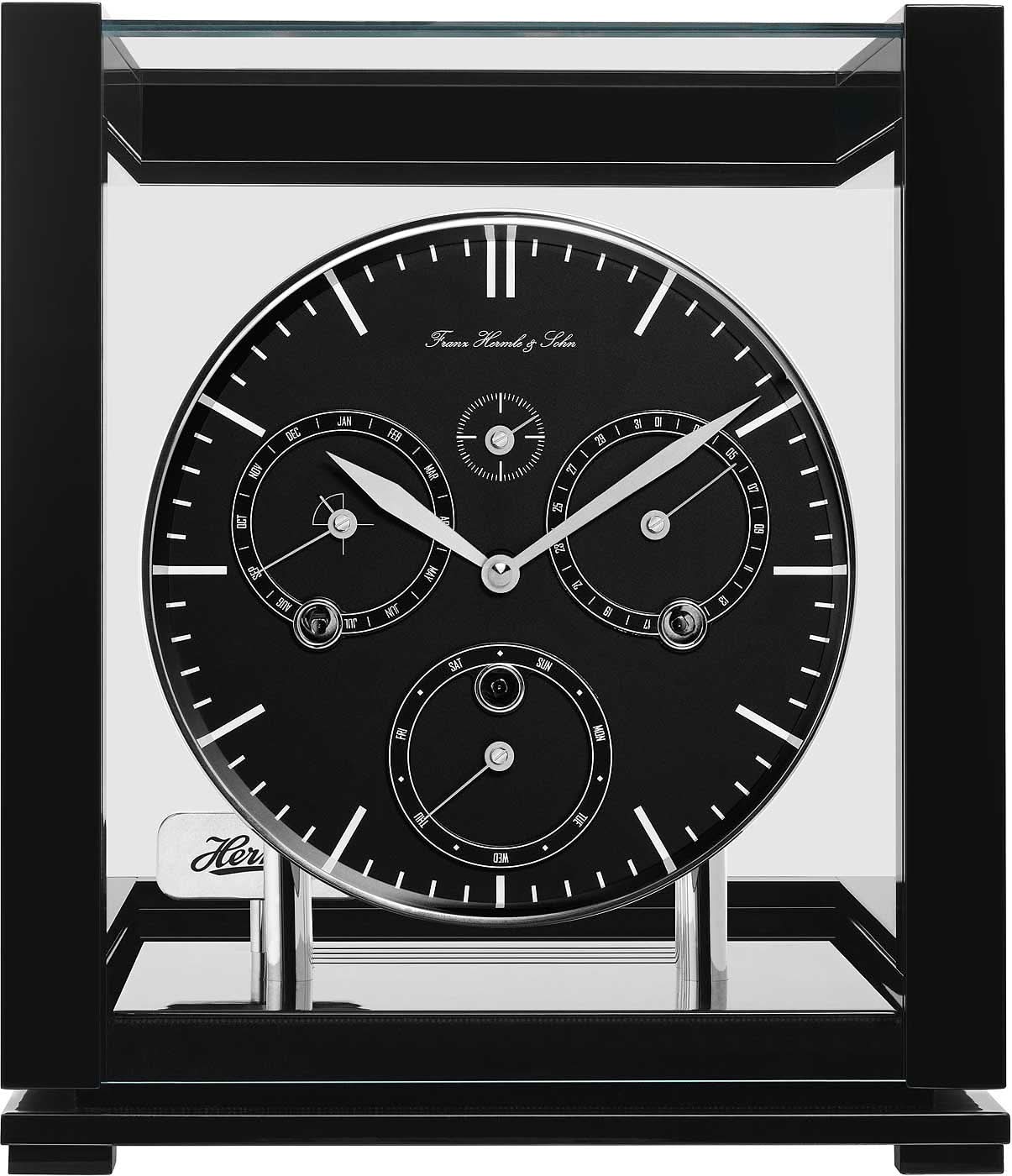 "Reloj de mesa de metal con esfera negra y manecillas en un marco de caja abierto"