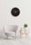 "Reloj de pared sobre pared blanca con esfera negra y manecillas de oro rosa"