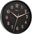 "Reloj de pared redondo con esfera negra y manecillas de oro rosa; borde negro"