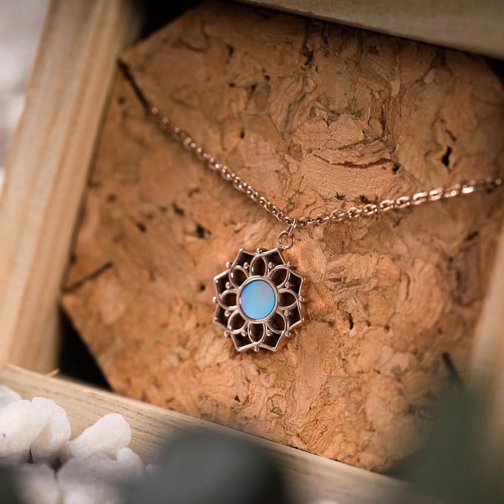 Collar con colgante redondo de nácar azul en montura metálica con forma de flor