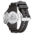 Vista trasera de reloj para hombre con correa de caucho negra e inserto de caja plateado.