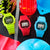 Vier G-Shock Digitaluhren in Neonfarben: gelb, rot und blau mit LCD-Anzeige.