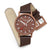 Reloj unisex Mondaine con correa de cuero marrón; esfera marrón, detalles rojos, hebilla ajustable.