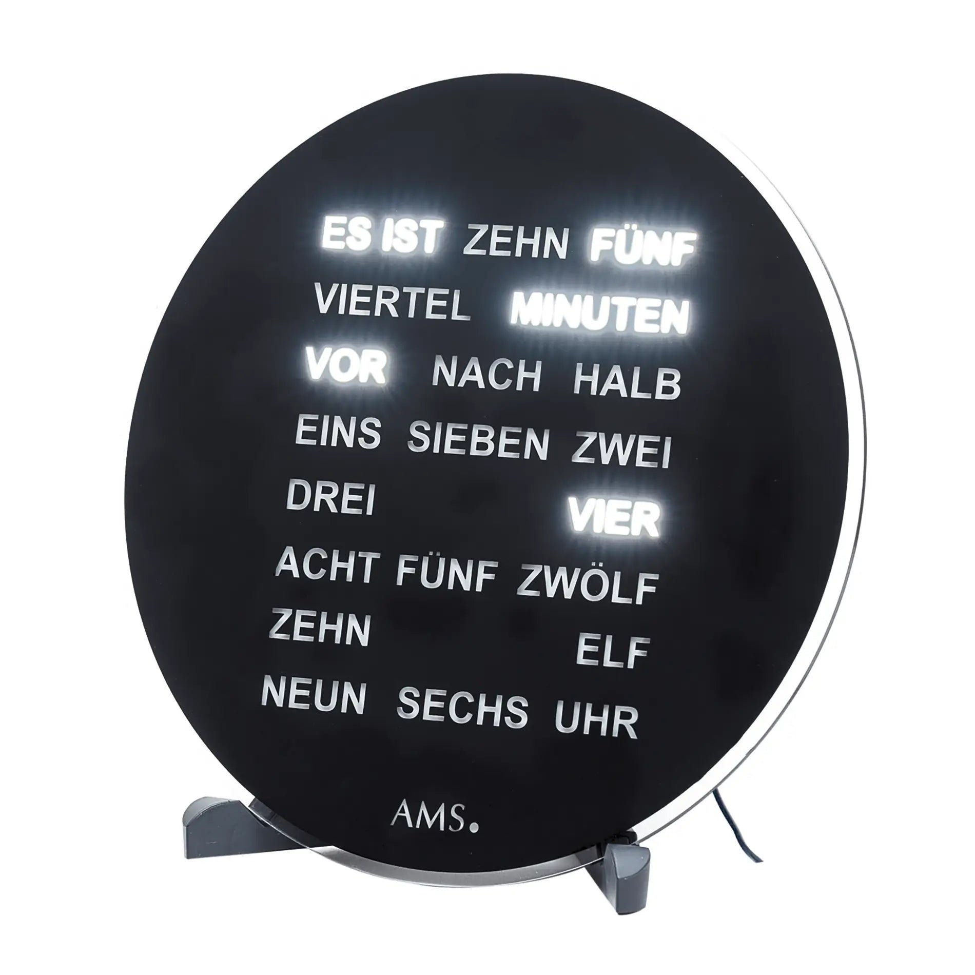 Reloj LED redondo AMS con pantalla de palabras, esfera negra y texto luminoso sobre soportes