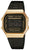 Reloj digital vintage con bisel dorado, correa de metal negra y pantalla digital