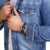 Reloj unisex en la muñeca, esfera azul y correa textil azul oscuro, vista de cerca.