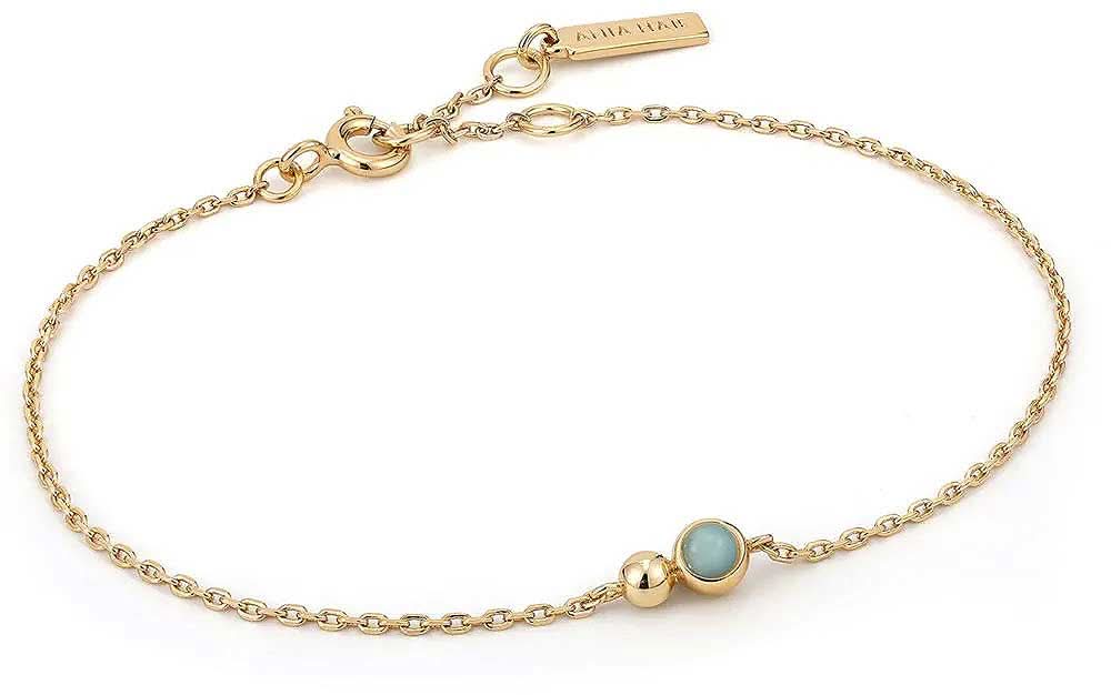 Pulsera dorada con eslabones y pequeños dijes de bolitas, piedra de bisutería azul