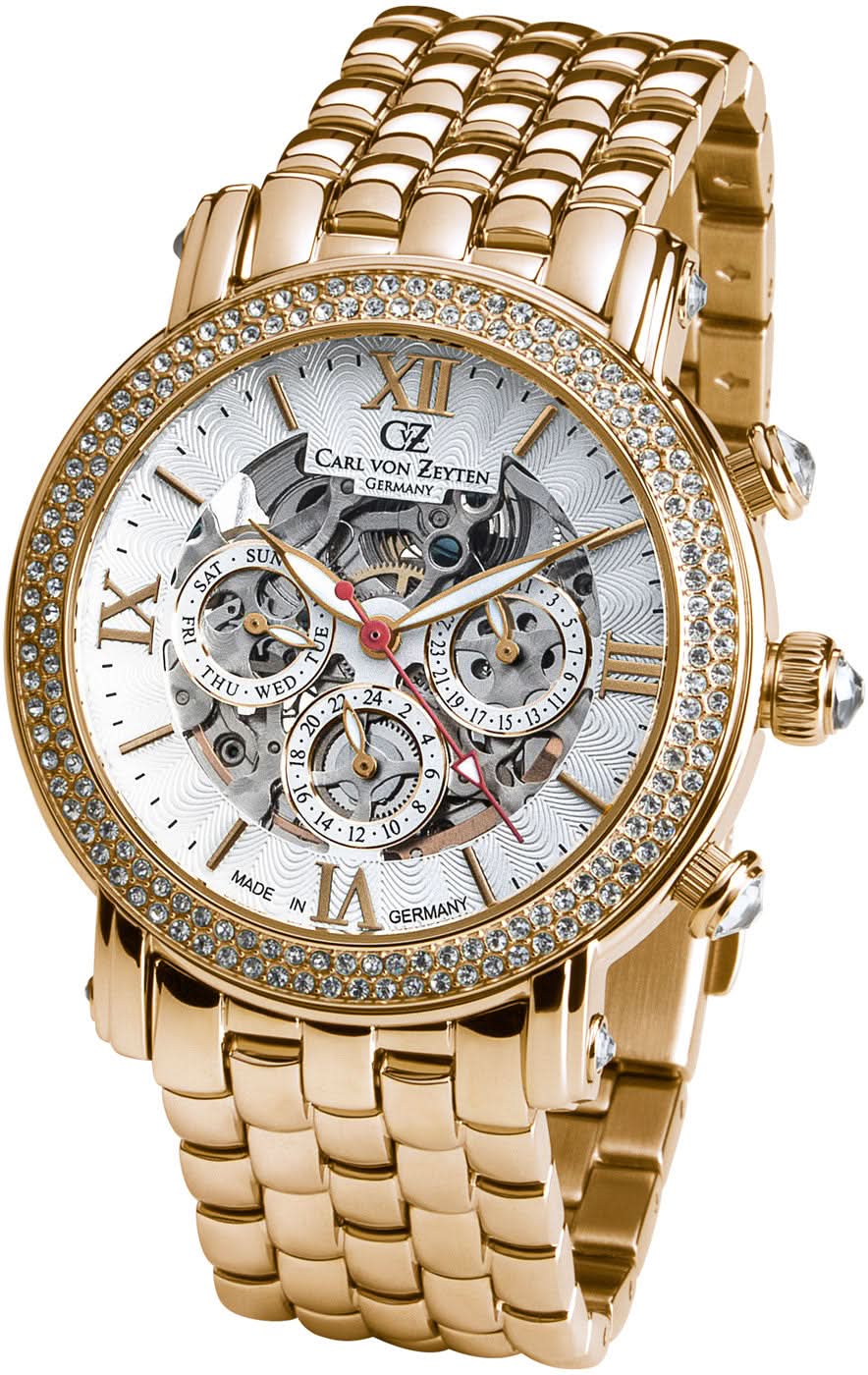 Reloj de mujer en tono dorado con correa de metal, bisel brillante y esfera blanca con movimiento esqueleto