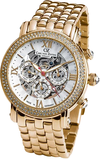 Reloj analógico dorado con bisel de pedrería, esfera blanca y números romanos