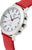Reloj de mujer en primer plano: caja plateada con pulsadores, correa de cuero roja, esfera blanca.