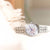 "Reloj de mujer con pulsera de acero inoxidable plateado y esfera de nácar claro, manecilla azul"
