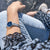 Reloj de mujer en la muñeca con esfera azul y correa de metal plateado