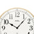 Wanduhr mit weißem Ziffernblatt, schwarzen Zeigern und AMS-Schrift, Messingrahmen