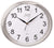 Reloj de pared ovalado: esfera blanca con números y manecillas negras, marco plateado