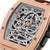Reloj de hombre con correa de cuero marrón y bisel en oro rosa, movimiento esqueleto con logo