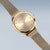 Reloj Bering para mujer con esfera beige, brazalete de malla milanesa y agujas doradas