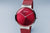 Reloj Bering con esfera roja, dos agujas y correa milanesa burdeos