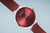 Reloj Bering con esfera roja y bisel plateado, correa de malla burdeos