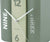 Reloj de mesa con forma de libro en cartón, color verde menta, vista cercana: números 12/6 y manecillas.