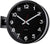 "Reloj de pared con esfera negra, números blancos, manecillas rojas y soporte de pared"