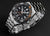 Reloj de buceo para hombre con esfera negra, marcadores naranjas y correa de acero