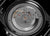 Movimiento visible con fondo de metal, tornillos y estampado "Marc Sons"