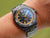 Reloj de buceo para hombre en la muñeca, esfera negra con bisel azul y correa de metal