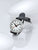 Reloj de hombre con correa de cuero negra, caja plateada y esfera blanca