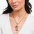 Collar con cadena de eslabones dorados y ojo redondo con piedra morada