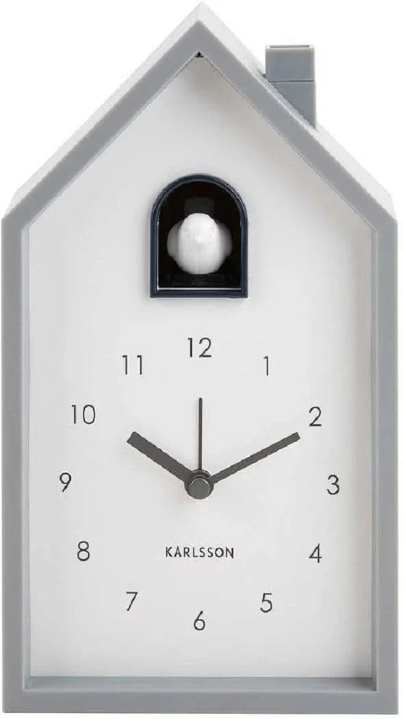 Reloj cucú con esfera blanca y ventana negra, pájaro blanco en la casa