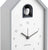 Reloj de cuco de cerca: carcasa gris y pájaro blanco en ventana negra