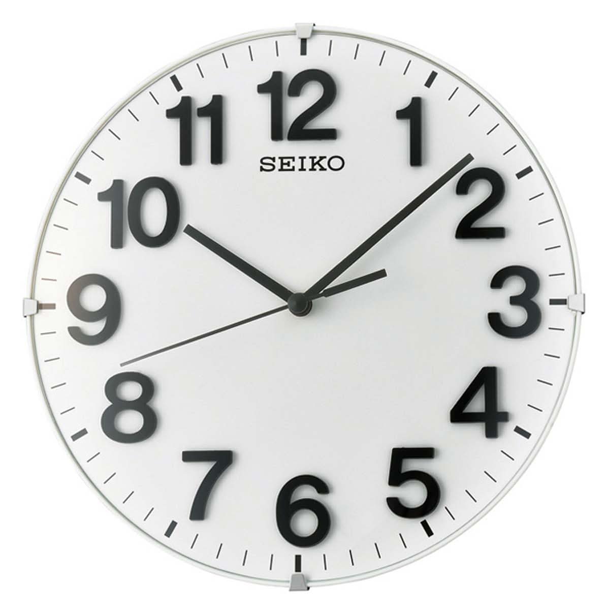 Reloj de pared Seiko con esfera blanca y manecillas negras, caja redonda de plástico