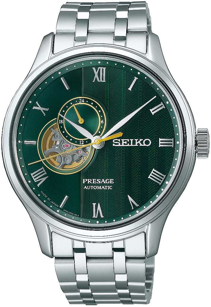 Reloj de hombre con esfera verde, apertura de corazón visible, números romanos y correa de acero inoxidable