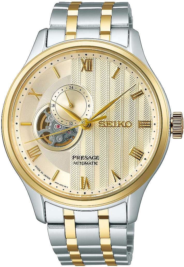 Reloj de hombre con correa de metal en tono dorado y plateado, esfera redonda con números romanos