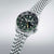 Pulsera de hombre de lado: correa de acero inoxidable, esfera verde oscuro con visualización de fecha