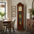 Holz-Standuhr mit Glasfront, rundem Zifferblatt und Mondphasenanzeige, goldene Pendelgewichte