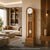 Holz-Standuhr mit rundem Zifferblatt und Pendel, hoher Standfuß im geraden Gehäuse