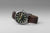 Reloj Seiko para hombre con esfera oscura, correa de cuero marrón e índices luminosos