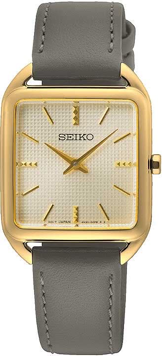 "Reloj de mujer con caja rectangular dorada, esfera blanca y correa de piel gris."